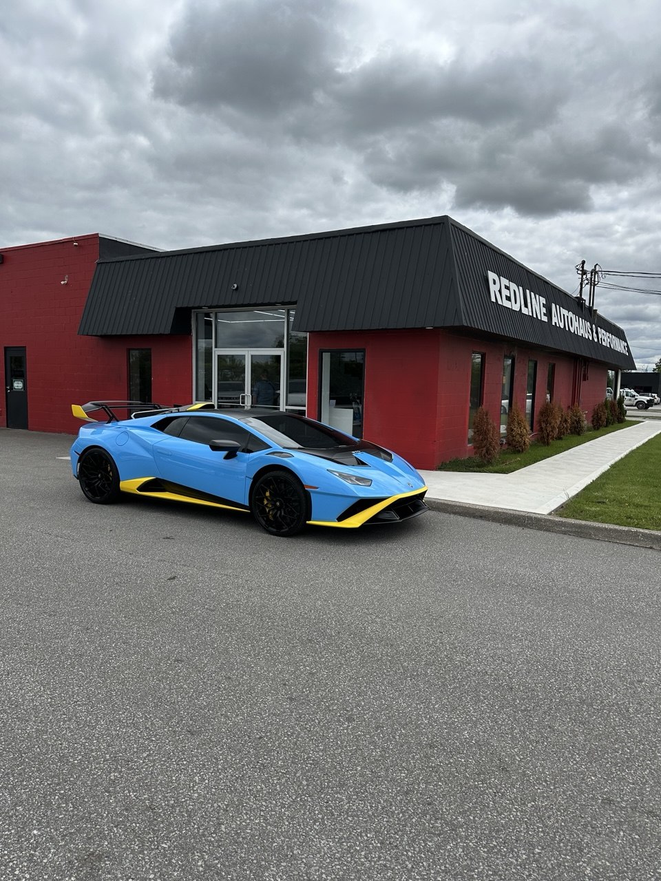 Blue Lamborghini parked outside Redline Autohaus